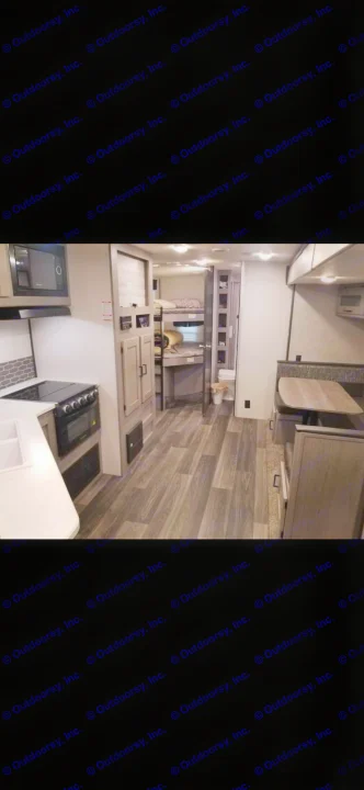 Interior view of a spacious rv rental, featuring a full kitchen, comfortable dinette, and convenient bunk beds.. Heartland RVs Mallard 2021
