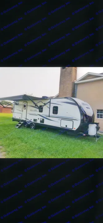 White and black Mallard RV travel trailer on a lush lawn, ideal for your RV rental getaway.. Heartland RVs Mallard 2021