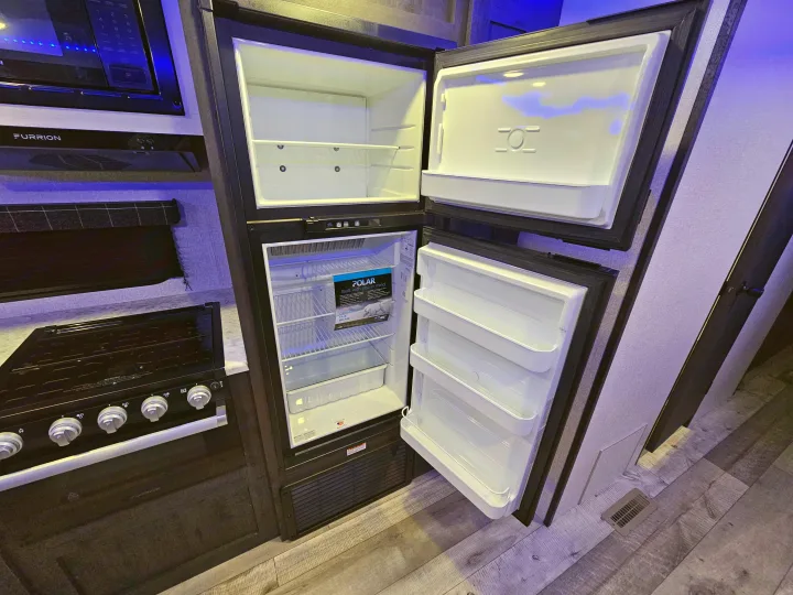 This RV rental offers a well-equipped kitchen with an open refrigerator, microwave, and Furrion stovetop for your travels.. KZ 312 Bunk House 2022