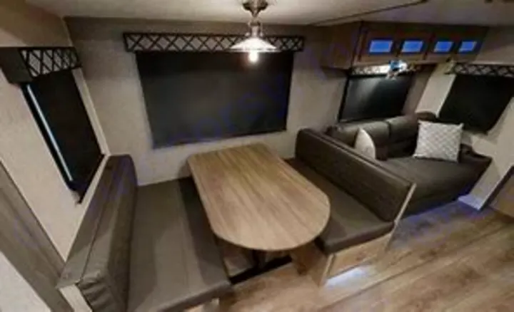 Inside this RV rental: a modern interior featuring a comfortable dinette with bench seating and a sofa lounge area.. Coachmen Other 2020