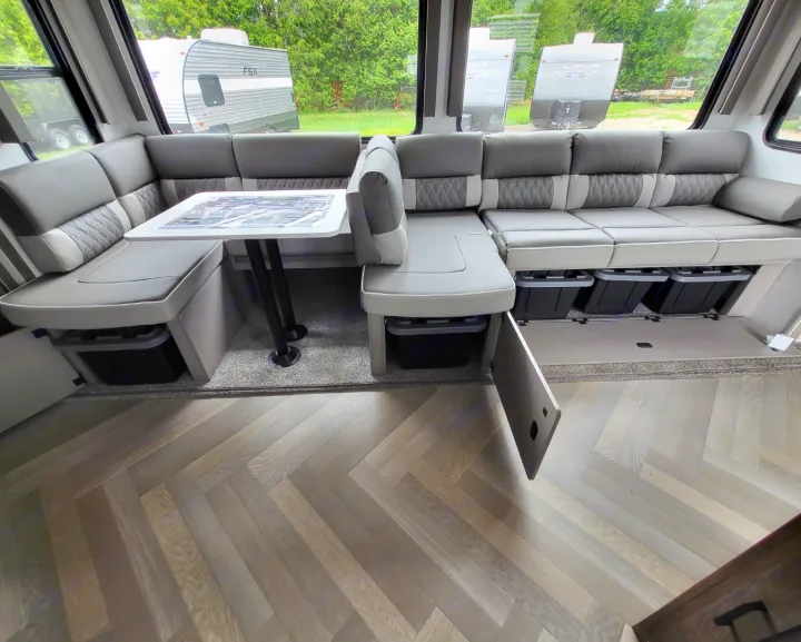 RV rental with modern gray U-shaped dinette, storage under seating, and herringbone wood-look floor.. Forest River Salem 2022