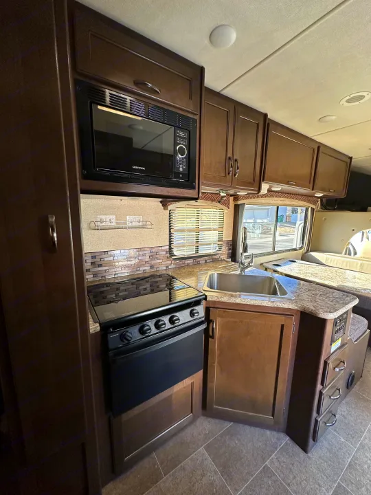 RV rental: Bright, modern kitchen featuring microwave, stove, sink, and spacious adjacent dinette.. Thor Chateau 2018