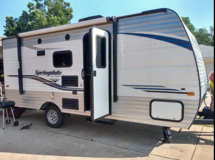 This Springdale RV rental is shown parked with its door open and awning out, ready for your next adventure.. Keystone Springdale 1800BH 2019