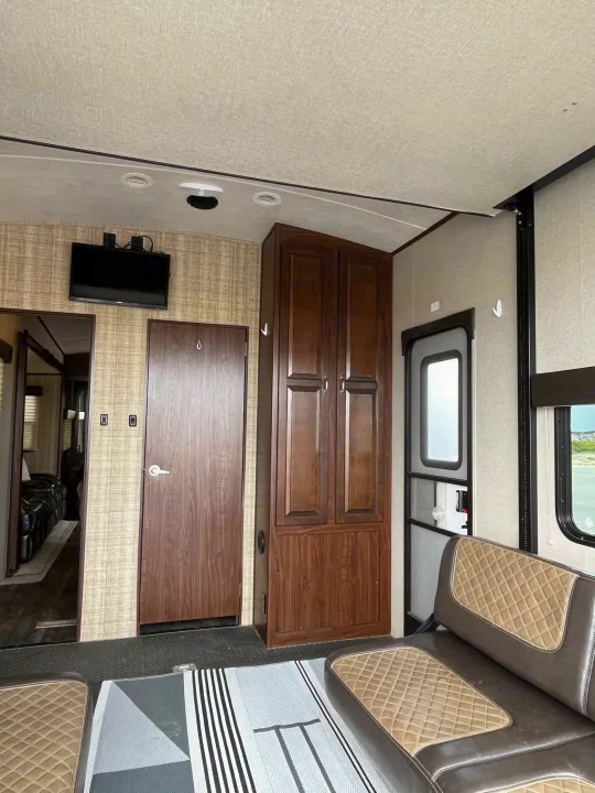 RV rental's versatile interior: features a large living space, quilted seating, TV, and durable rubberized floor.. Other Other 2017