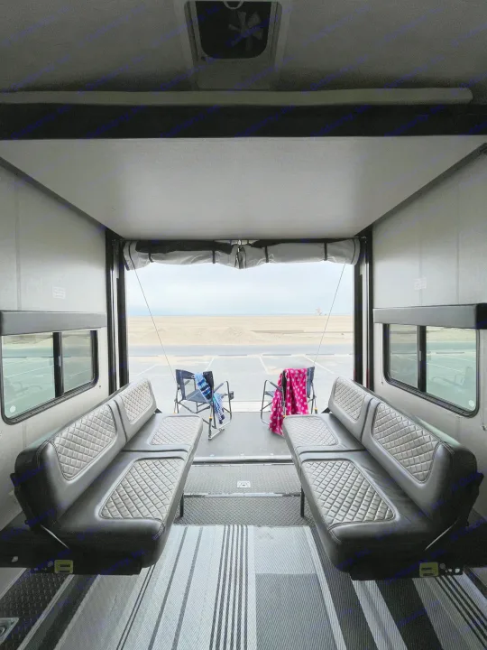 RV rental interior: open ramp reveals a beach view. Features comfortable quilted sofas & chairs for relaxing by the sand.. Other Other 2017