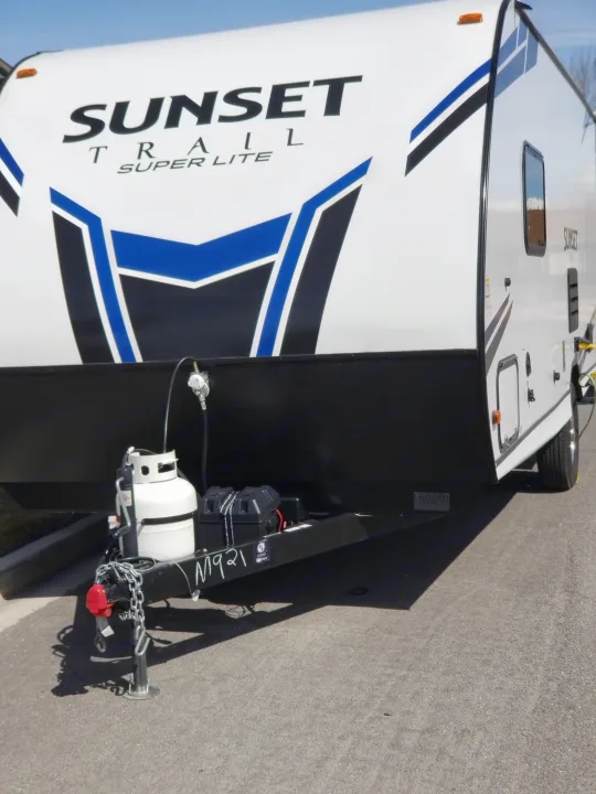 This white RV rental travel trailer, a Sunset Trail Super Lite, with blue graphics, is ready for adventure.. Crossroads RV Sunset Trail Super Lite 2021