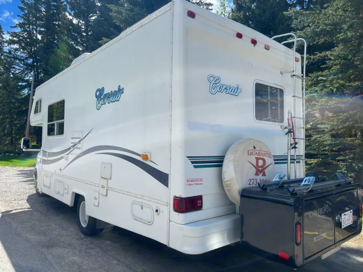 This white Corsair RV motorhome rental features a rear cargo box with a bike rack, ideal for adventures.. Other Other 2005
