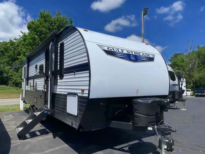 A sleek white and black Gulf Stream travel trailer, with steps extended, ready for your next RV rental adventure.. Gulf Stream 268BHS 2023