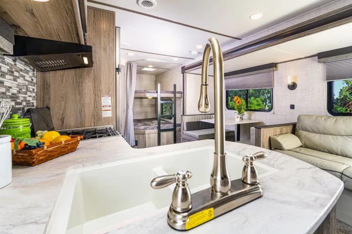 Spacious RV rental interior featuring a modern kitchen, bunk beds, dinette, and cozy living area. Perfect for families.. Gulf Stream 268BHS 2023
