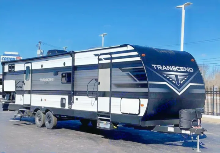 A long black, gray, and white Transcend travel trailer with multiple windows and doors. Great for an RV rental!. Grand Design Transcend Xplor 265BH 2022