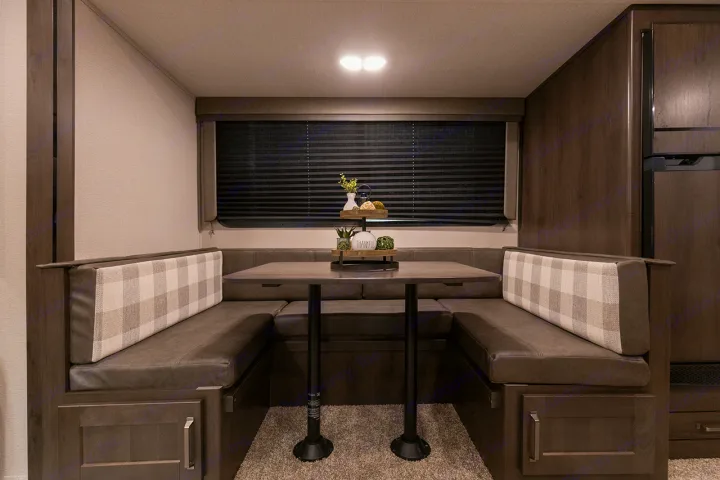 Experience comfort in this RV rental! A cozy dinette features U-shaped booth seating with a table, ideal for your next trip.. Grand Design Transcend Xplor 265BH 2022