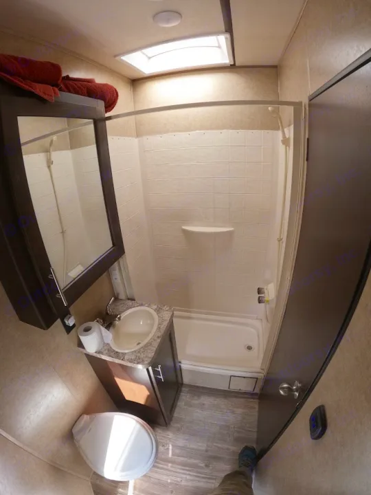 This RV rental bathroom features a toilet, sink, and shower/tub combo, perfect for travel & camping.. Forest River XLR Boost Toy Hauler 2018