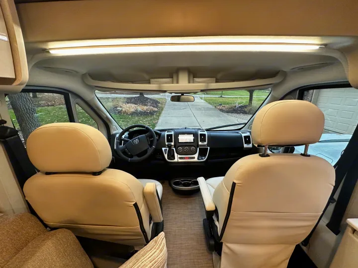Spacious rv rental interior: Comfortable front seats & dashboard visible from rear, ready for adventures.. Thor Tellaro 2022