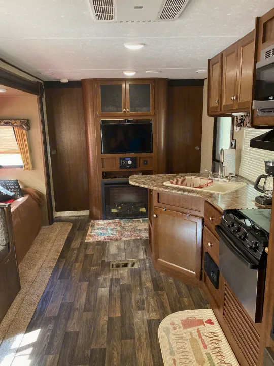 This RV rental offers a full kitchen, entertainment center with TV/fireplace, and comfortable living space.. Keystone RV Hideout 2016