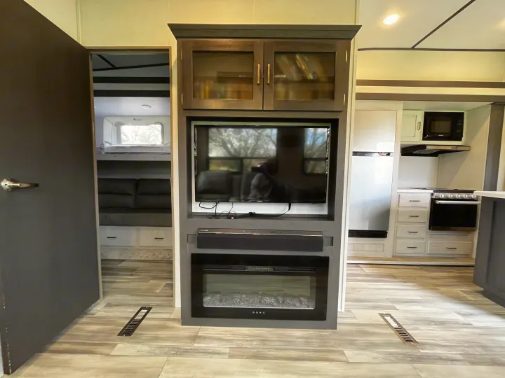 RV rental: Modern interior featuring entertainment center with TV/fireplace, full kitchen, and separate bunk room. Comfort on wheels!. Keystone Sprinter 2023