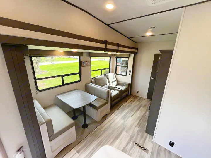 Bright and modern rv rental interior with a comfy dinette, recliners, and scenic windows for your travels.. Keystone Sprinter 2023