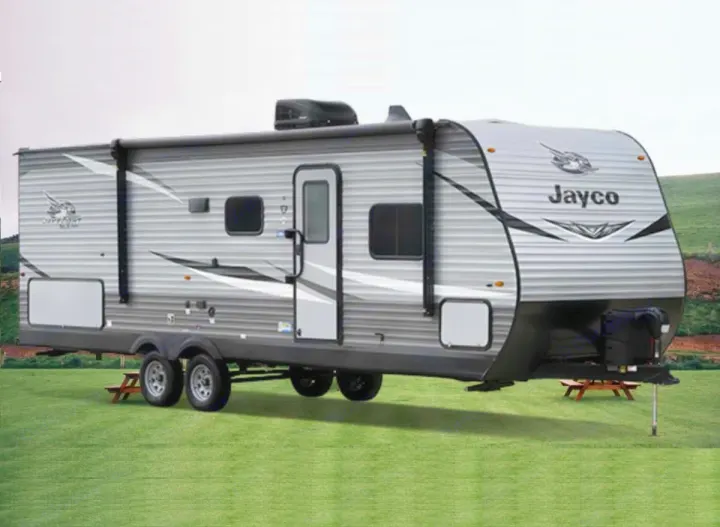 Grey Jayco travel trailer RV rental parked on grass. Perfect for family camping adventures.. Jayco Jay Flight 2022
