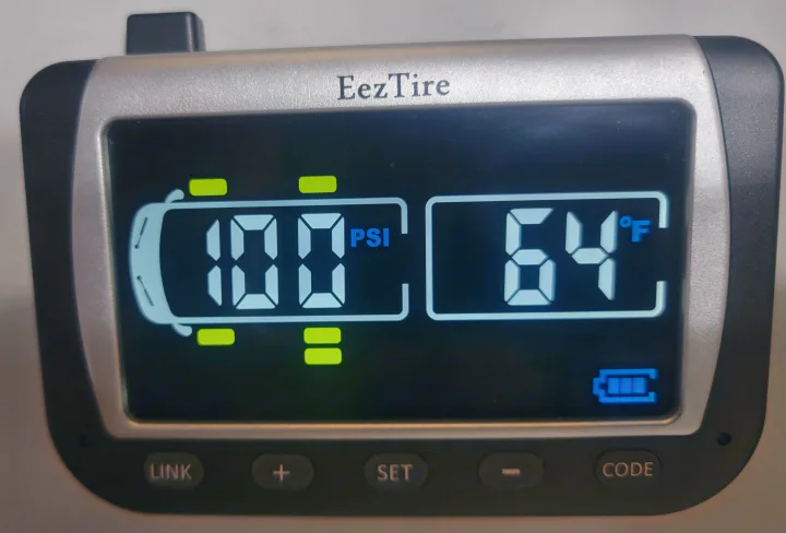 This EezTire RV tire pressure monitor displays 100 PSI and 64°F, with full battery. Essential for rv rental safety.. Thor Hurricane 2012