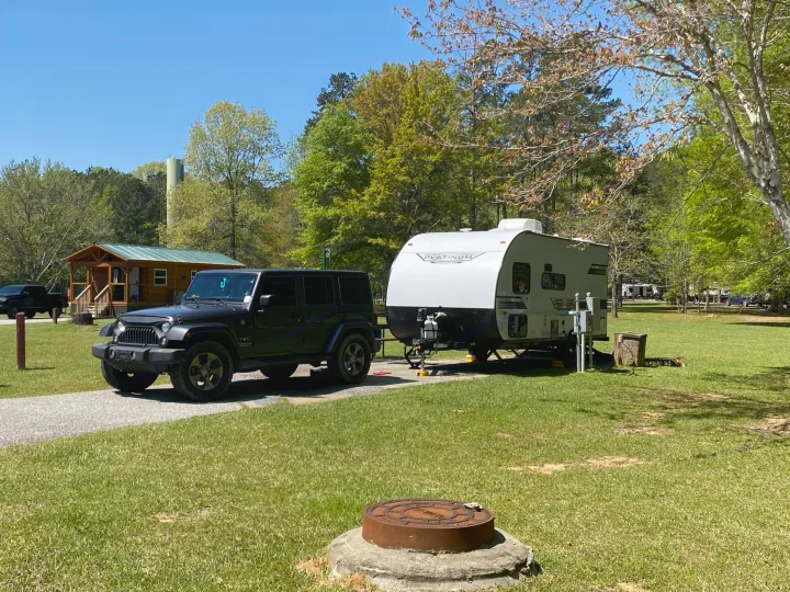 Black Jeep Wrangler & white **rv rental** parked at a sunny campground. Ideal for your next outdoor adventure.. Forest River Salem FSX PLATINUM 2021