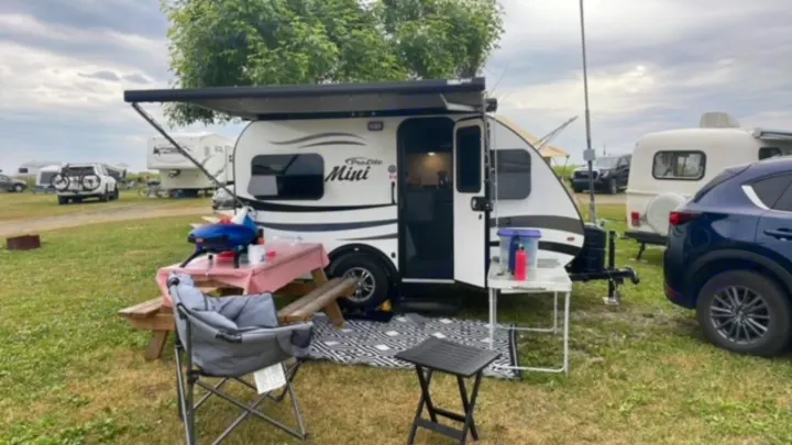 A ProLite Mini travel trailer at a campsite, ready for adventure. Ideal for an RV rental getaway.. Prolite Prolite Trailer 2022