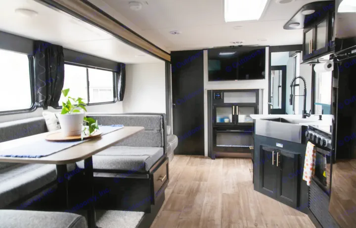Modern RV rental interior with dinette, full kitchen, and living area, perfect for travel comfort.. Forest River Cherokee Grey Wolf 2022
