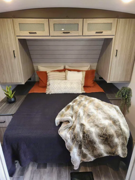 Plush bed and smart storage in this modern RV rental bedroom. Experience comfort on the road.. Keystone RV Passport GT 2022