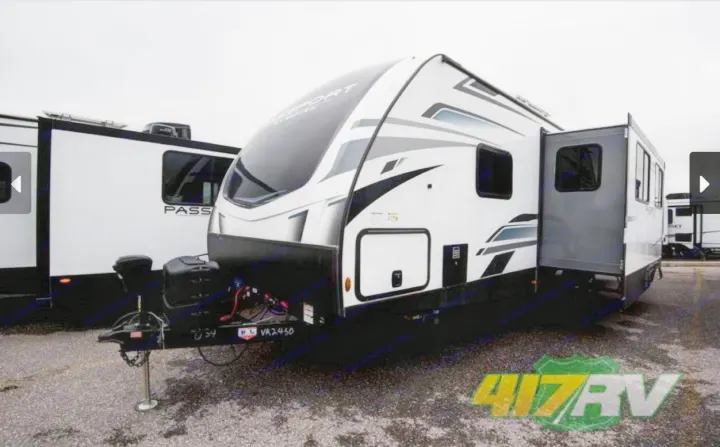 Explore the outdoors with this modern white and black travel trailer, ideal for RV rental.. Keystone RV Passport GT 2022
