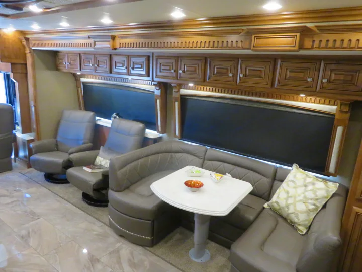Luxury motorhome rv rental interior with wood cabinetry, recliners, and dinette for comfortable travel.. Monaco Signature 2019