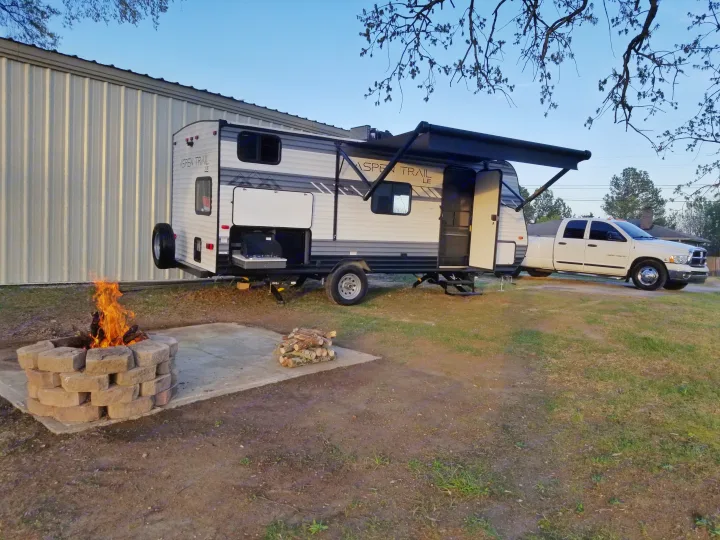 Enjoy a cozy RV rental experience! An Aspen Trail travel trailer with outdoor kitchen, campfire, and truck ready for adventure.. Aspen Trail LE 2022