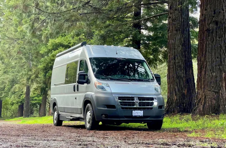 Explore nature with this light gray camper van rv rental parked on a forest path.. Hymer Sunlight Van 1 2018
