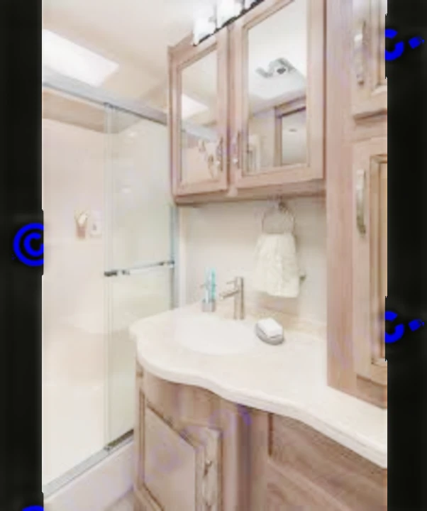 This compact RV rental bathroom showcases a glass shower, vanity with sink, and wood cabinets, ideal for travel.. Jayco Precept Prestige 2021
