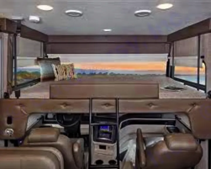 Spacious RV rental interior featuring a large cab-over bunk bed above the driver's cockpit. Perfect for family road trips.. Jayco Precept Prestige 2021