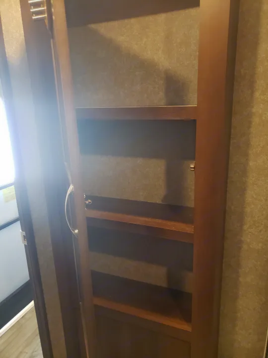 RV rental: functional cabinet with multiple wooden shelves for convenient storage of essentials.. Jayco Octane 2019