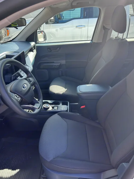 Interior of a Ford Maverick pickup, featuring the steering wheel, dash, and front seats. Great for rv rental adventures.. Ford Maverick 2024