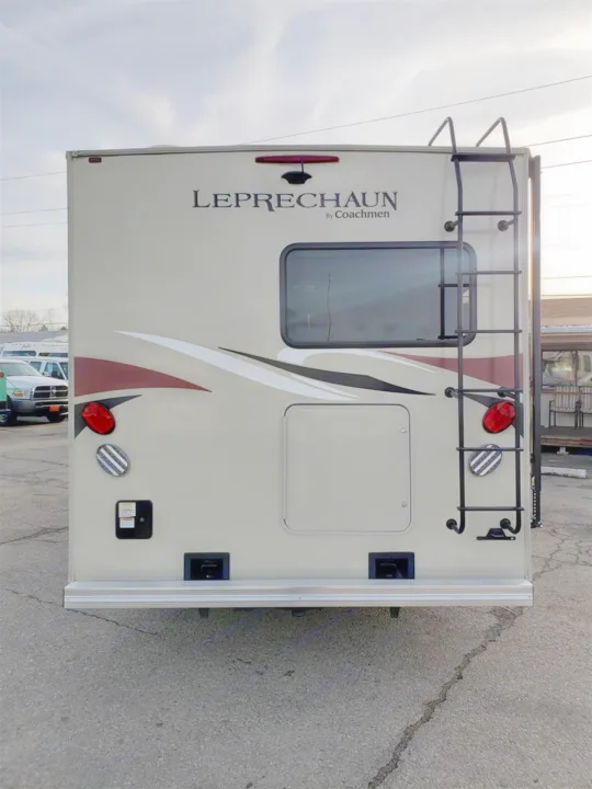 Rear view of a tan Coachmen Leprechaun RV. Features include a ladder, window, and storage compartment, suitable for rv rental.. Forest River Coachmen Leprechaun 2017