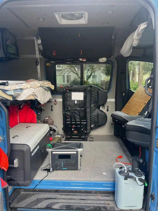 RV rental interior: a fully equipped camper van with bed, portable power, fridge, and sink.. Mercedes-Benz Sprinter 2021