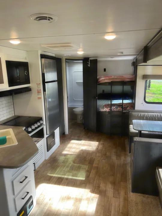 Spacious RV rental interior with kitchen, dinette, bunk beds, and bathroom.. Keystone Hideout 2022