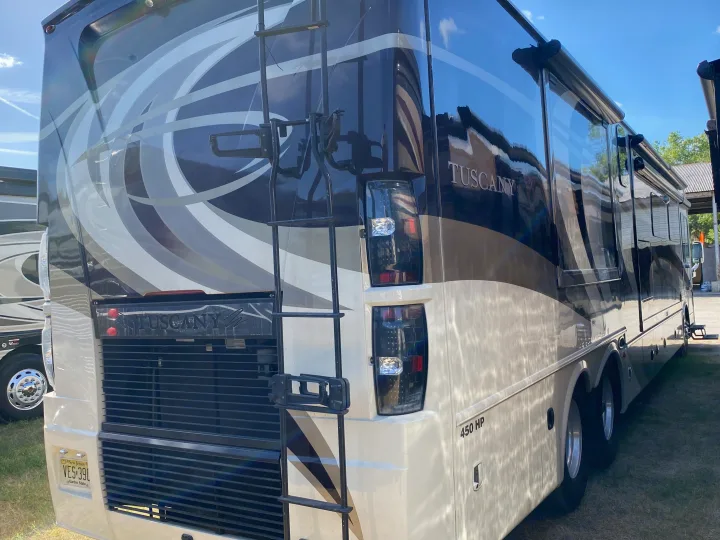 Rear view of a large, luxurious Tuscany motorhome (450 HP), featuring a ladder. Consider this for your RV rental.. Thor Motor Coach Tuscany 2015