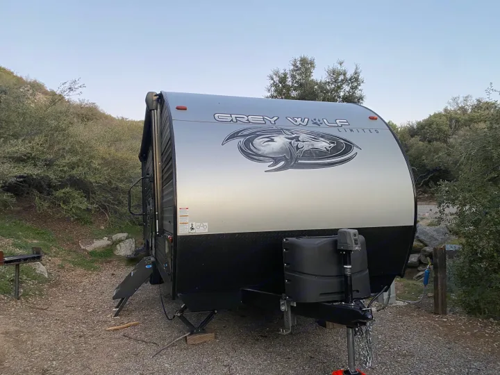 Grey Wolf Limited RV rental travel trailer parked at a scenic campsite. Ready for adventure and outdoor camping.. Forest River Cherokee Grey Wolf 2021