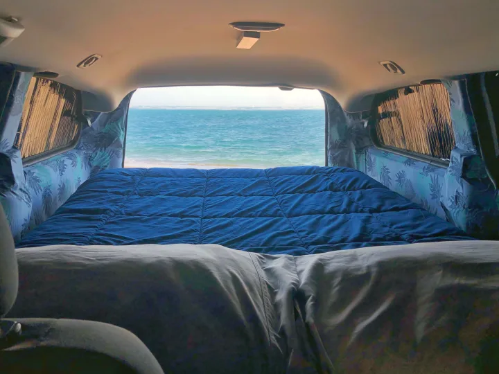 Cozy RV rental with a comfy bed and serene ocean view. Ideal for beach adventures and van life camping!. Dodge Grand Caravan 2010
