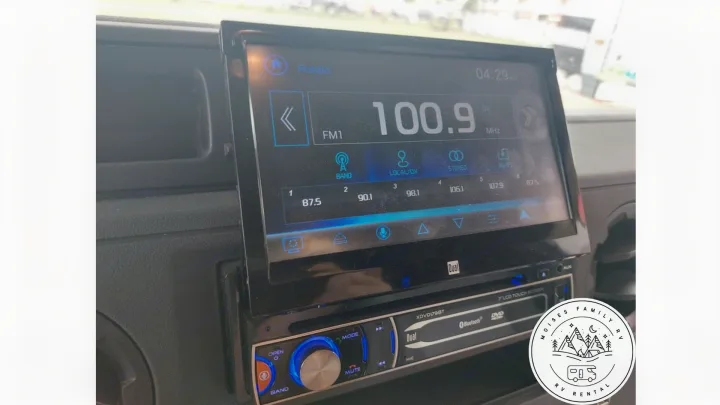 Inside an RV rental: a Dual touchscreen stereo displaying 100.. Gulf Stream Conquest 2021