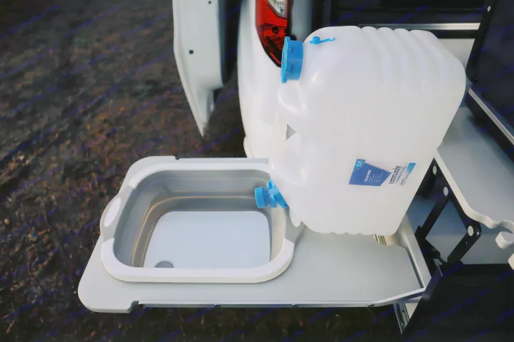RV rental perk: Translucent water container filling a portable collapsible sink. Perfect for camp kitchens.. Ford Transit Connect Wagon 2022