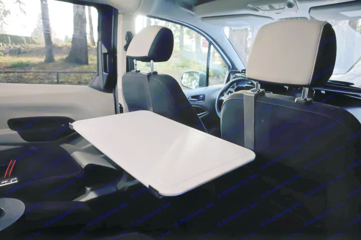 RV rental interior: A white tray table, perfect for mobile work or dining, extends from the front passenger seat back.. Ford Transit Connect Wagon 2022