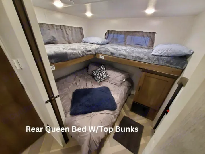 RV rental: Cozy bunk room featuring a queen bed below two top bunks, ideal for family sleeping in this camper.. Forest River Salem 2022