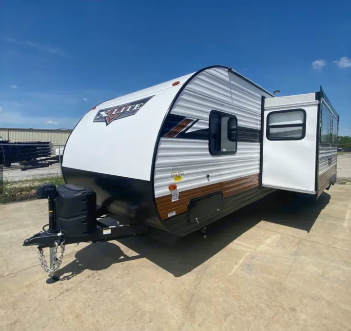 New X-Lite travel trailer, white & brown, with slide-out. Ideal for your next rv rental outdoor trip.. Forest River Forest River 2023