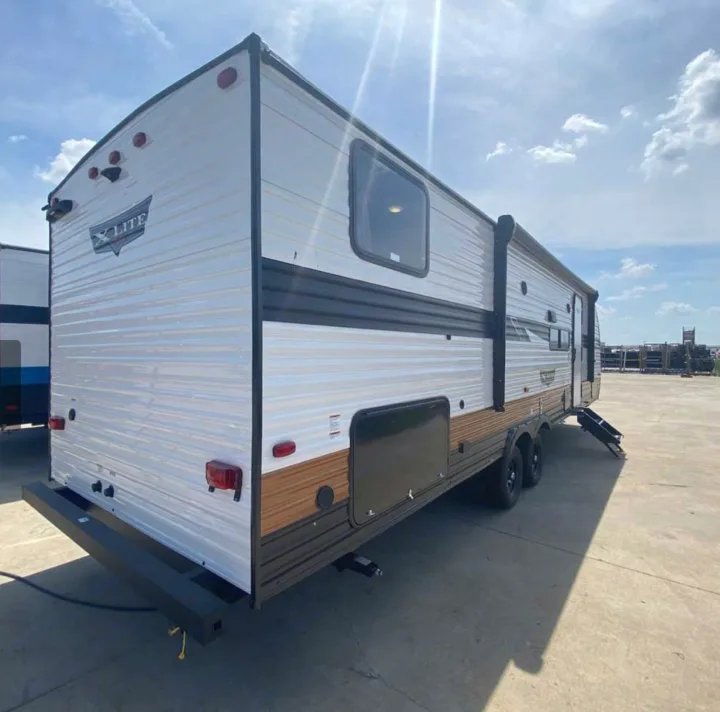 White X-Lite travel trailer RV rental, seen from the rear, on a sunny day. Perfect for your next outdoor adventure.. Forest River Forest River 2023