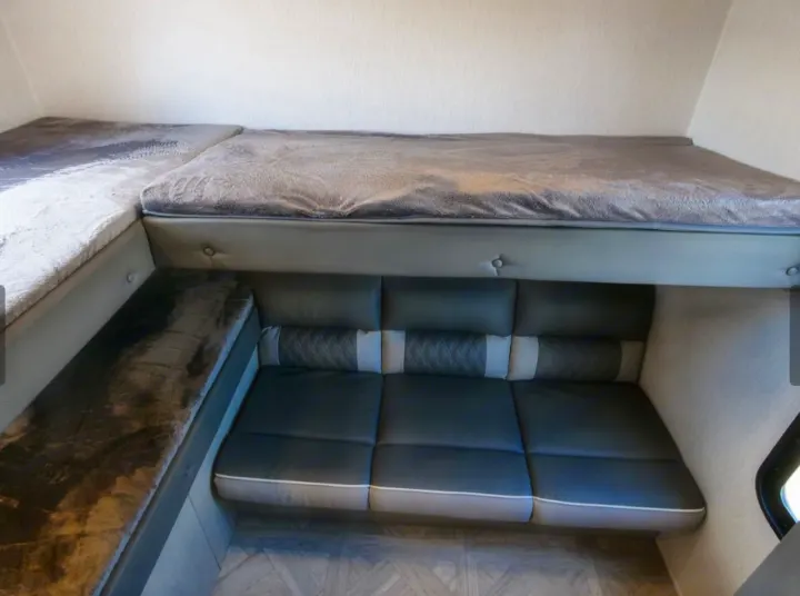 RV rental interior: Stacked bunk beds and a convertible sofa/dinette provide efficient sleeping and seating space.. Forest River Forest River 2023