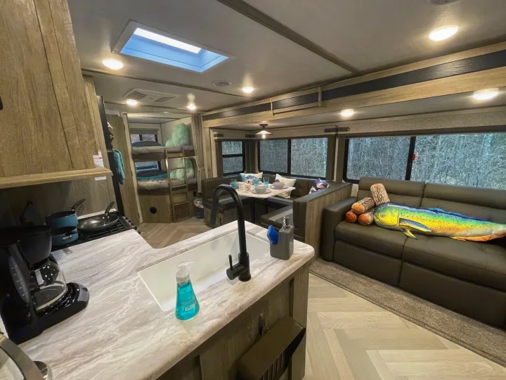 This rv rental showcases a full kitchen, dinette, bunk beds, and a comfortable living area with large windows for your next adventure.. Forest River Salem Hemisphere HL 2021