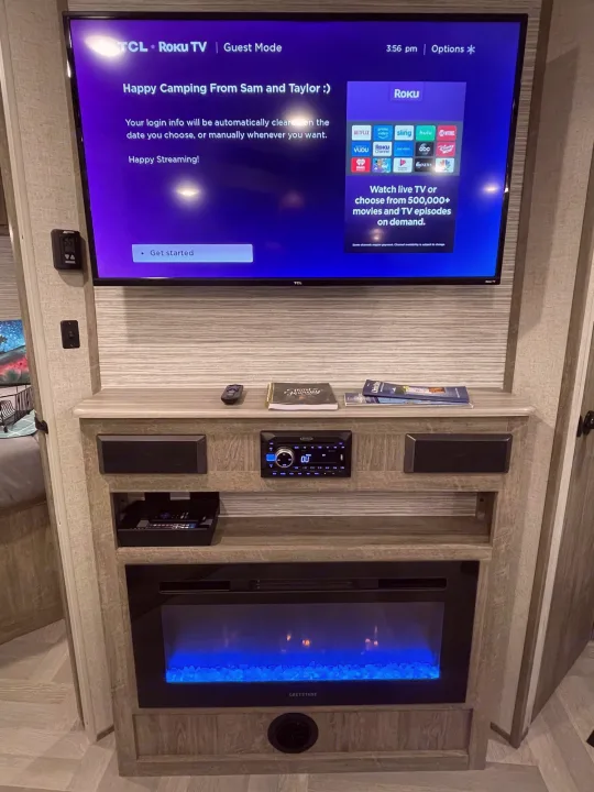 RV rental entertainment unit with Roku TV, stereo, & electric fireplace, set for happy camping and streaming.. Forest River Salem Hemisphere HL 2021