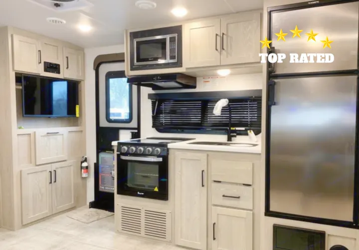 Experience this top-rated rv rental: a compact, modern interior with full kitchen (microwave, oven, fridge, sink) and TV/storage.. Forest River Rockwood Roo 2021
